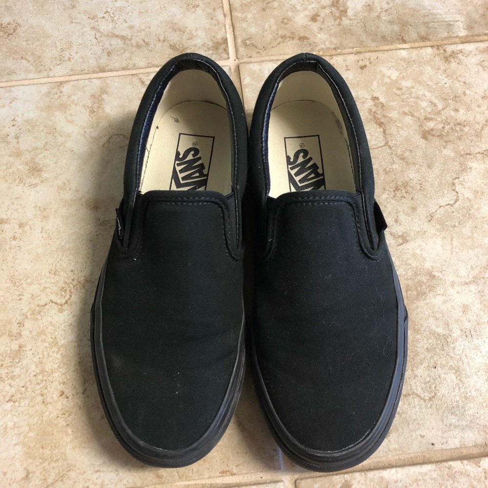 All black slip on vans